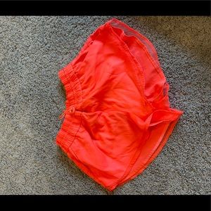 Neon orange running shorts